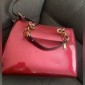 Brand new red patten leather purse. Comes with adjustable cross body straps.